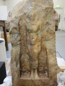 Image of a stone statue showing a portion of the statue that has been steam cleaned and not steam cleaned 